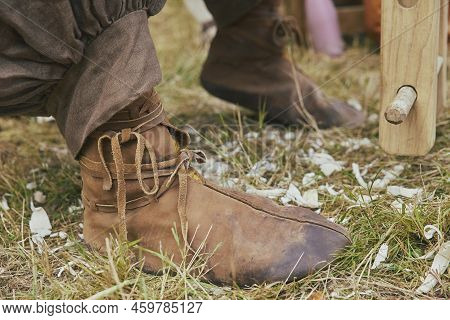 Retro Photo. Leather Boots Of A Carpenter Working In The Yard