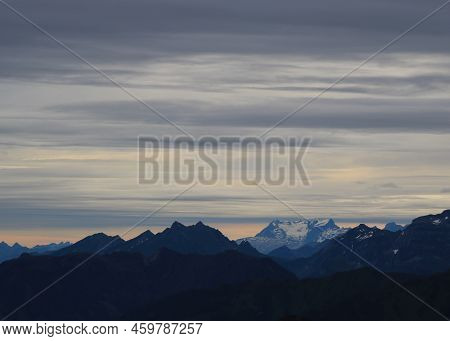 Scene Seen From Mount Brienzer Rothorn On A Rainy Summer Morning. Clouds Over Mount Titlis.