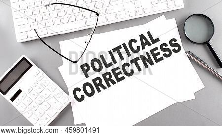 Political Correctness Text On Paper With Keyboard, Calculator On A Grey Background