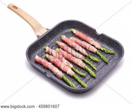 Aspargus Covered With Bacon In A Grill Frying Pan Isolated On White Background