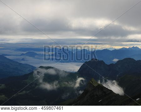 Sunrise Scene Seen From Mount Brienzer Rothorn. View Towards Stanserhorn And Lucerne. Fog Lifting Sl