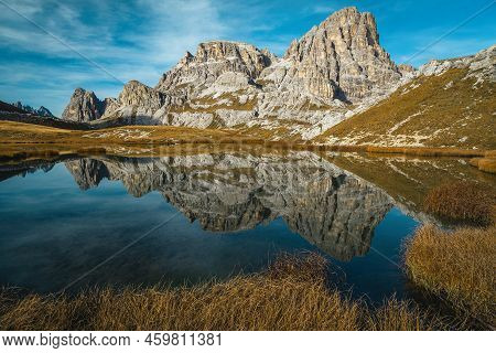 Stunning Autumn Scenery With Beautiful Mountain Lake Lago Dei Piani. Mountain Ridge Reflection In Wa