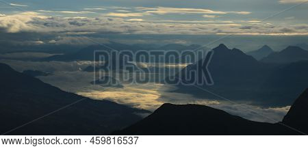 Sunrise View From Mount Brienzer Rothorn. Mount Stanserhorn And Sea Of Fog On A Cloudy Summer Mornin