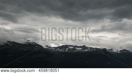 Monochrome Image Of Dark Clouds Over Mount Faulhorn And Other Mountains In The Bernese Oberland.