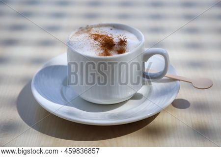 A Cup With Latte Macchiato, Cafe Latte Stands On A Table.