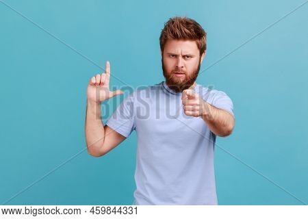 Portrait Of Disrespectful Rude Bearded Man Showing Loser Gesture And Pointing On You, Abuser, Blamin