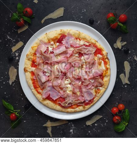 Traditional Italian Pizza With Ham, Salami, Bacon And Roasted Rib