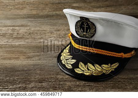 Peaked Cap With Accessories On Wooden Background, Space For Text