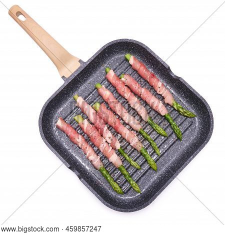 Aspargus Covered With Bacon In A Grill Frying Pan Isolated On White Background