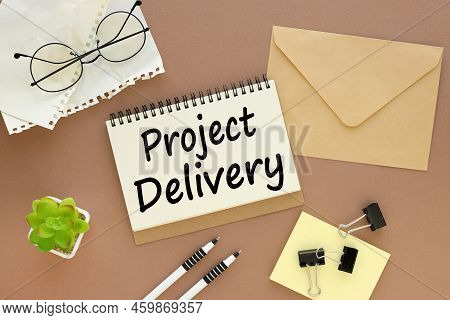 A Lot Of Stationery On The Tabl, Glasses, Envelope Brown Background Text On Torn Page. Project Deliv