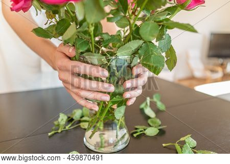 Woman Hands Holding A Vase With Roses