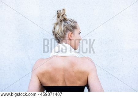 Half Body Rear View Shot Of A Gym Fit Caucasian Sporty Woman Dressed In Sportswear And With Her Hair