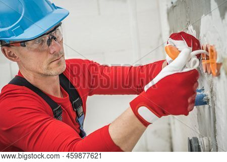 Caucasian Middle Aged Man In Protective Glasses And Blue Hard Hat Working With Electric Cables Insta