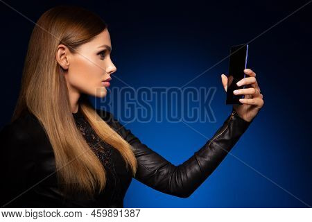 Beautiful Woman Handling Phon. Bright Makeup And Beautiful Hairstyle