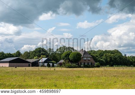 Zwolle, Overijssel, The Netherlands, 07 15 2022 - Dike View Over The Nature Fields, Trees And Clouds