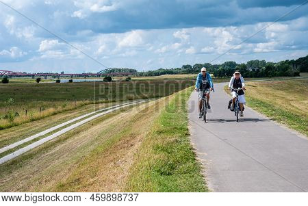Zwolle, Overijssel, The Netherlands, 07 15 2022 - Bicycle Path At The Dike Of The River Ijssel Flood