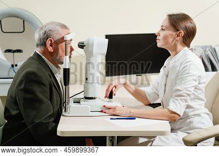 Ophthalmologist Examination Of Elderly Man On Corneo Topographer.modern Clinic