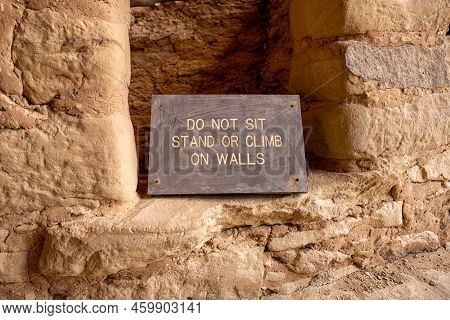 Do Not Sit Stand Or Climb On Walls Sign In Cliff Dwelling In Mesa Verde