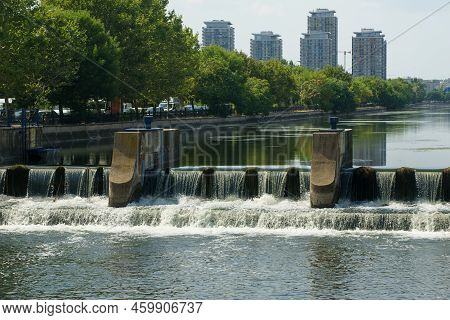 Bucharest, Romania - August 09, 2022: View With A Hydrotechnical Structure On The Dambovita River In