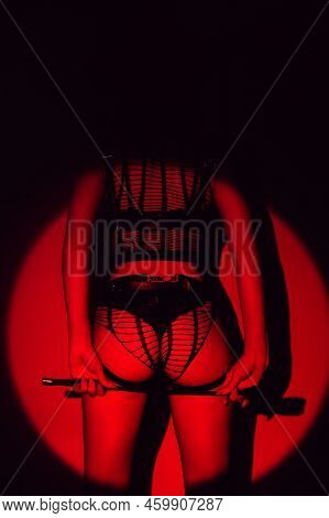 Woman With A Sexy Booty In Underwear And Panties Holds A Leather Flogger Whip In Her Hands For Bdsm 