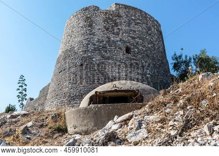Lekuresi Castle And A Military Concrete Bunker In The Foreground At Saranda, Albania