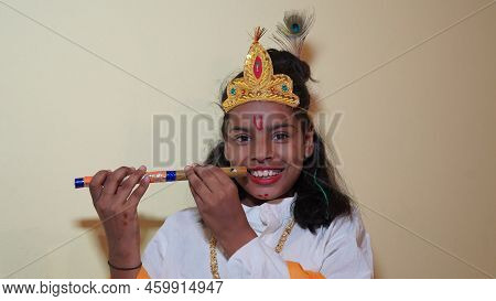 Happy Janmashtami Little Indian Boy Posing As Shri Krishna Or Kanha Or Kanhaiya With Flute.