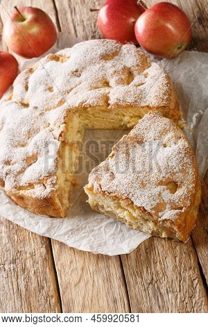 Tasty Homemade Sharlotka Apple Pie Close-up On A Parchment Paper On The Table. Vertical
