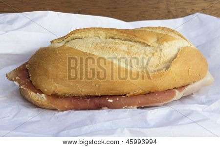 Spanish serrano ham sandwich on a napkin on a table