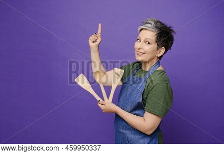 Mature Attractive Pritty Middle-age Woman Pointing Up By Finger To Copy Space And Dressed In Jeans A