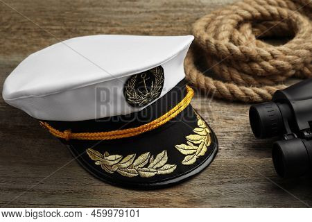 Peaked Cap, Rope And Binoculars On Wooden Background