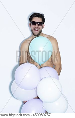Portrait Of One Funny Laughing Caucasian Handsome Brunet Man With Bunch Of Colorful Air Balloons In