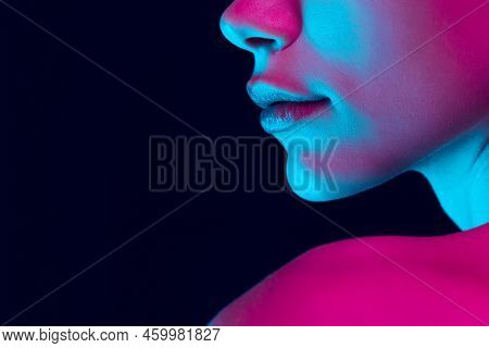 Closeup Female Lips, Cheeks And Nose Isolated Over Dark Background In Neon Light. Concept Of Cosmeto
