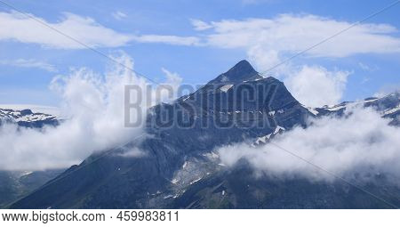 Peak Of Mount Oldehore Surrounded By Clouds.