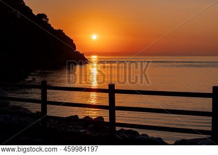 Beautiful View Of Orange Sunset Seascape With Rocks In Italy. Tropical Colourful Sunrise Landscape. 