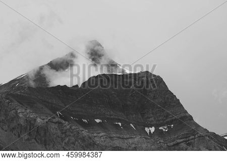 Monochrome Image Of Fog Creeping Around Mount Oldehore.