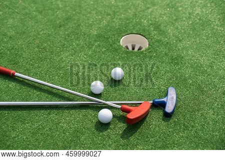 A Club Prepares To Hit A Ball During A Mini Golf Game