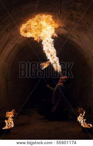 Young man blowing fire from his mouth
