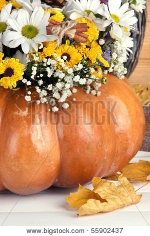 Beautiful autumn composition in pumpkin on table close up