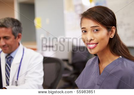 Portrait Of Female Nurse Working At Nurses Station