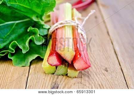 Rhubarb Tied With Twine With Leaf On Board