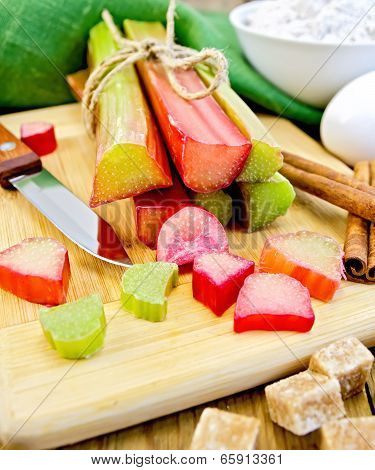 Rhubarb With Sugar And Knife On Board