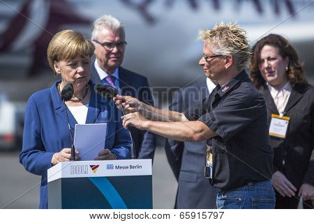 BERLIN, GERMANY - MAY 20, 2014: German Chancellor Angela Merkel (L) open up the International aviation and space exhibition ILA-2014.