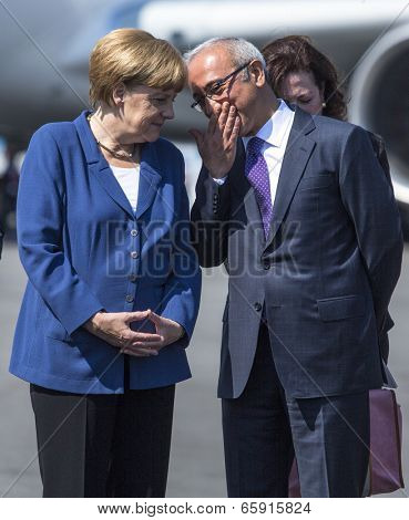 BERLIN, GERMANY - MAY 20, 2014: German Chancellor Angela Merkel (L), Turkish Minister of transport Lutfi Elvan (R) open up the International aviation and space exhibition ILA.