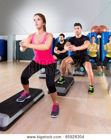 Cardio step dance squat people group at fitness gym training workout