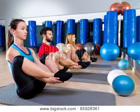 Pilates people group the seal exercise man and women at fitness gym