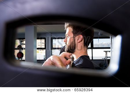 Barbell man weightlifting workout view through a weight bell hole