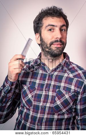 young man want comb his beard and moustaches
