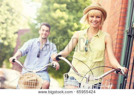 A picture of a young couple cycling in the city