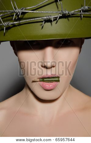 Female Soldier In Helmet Holding In His Mouth A Bullet