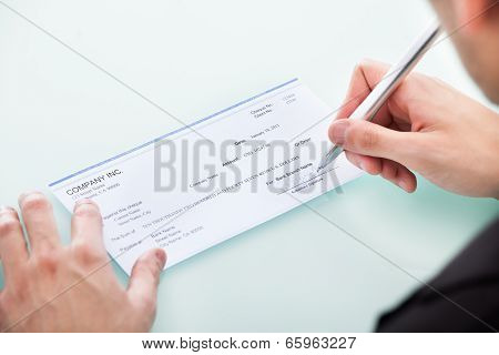 Businessman Signing On Cheque